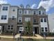 New two-story townhome featuring brick and siding facade, complemented by professionally landscaped front yard at 328 Chesapeak Commons St # 142, Garner, NC 27529