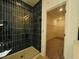 Elegant shower with dark tile and glass enclosure, with doorway to a closet at 3291 Roundly Rd # 14, New Hill, NC 27562