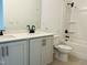 Well-lit bathroom featuring a double vanity with modern fixtures and a shower-tub combo with built-in shelving at 3291 Roundly Rd # 14, New Hill, NC 27562