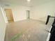 Spacious bedroom with plastic protection over the floor next to the stairs with black bannister at 3291 Roundly Rd # 14, New Hill, NC 27562