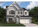 Charming two-story home with gray siding, stone accents, and a two-car garage at 3291 Roundly Rd # 14, New Hill, NC 27562