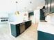 An open concept kitchen features a large island, stainless appliances, white counters and dark cabinets at 3291 Roundly Rd # 14, New Hill, NC 27562