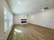 Spacious living room features hardwood flooring, large windows, recessed lighting, and a modern fireplace at 3291 Roundly Rd # 14, New Hill, NC 27562