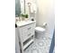 Half-bath features patterned tile flooring and updated vanity at 35 Rogerson Dr, Chapel Hill, NC 27517
