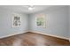 Bedroom features hardwood floors, a ceiling fan and two windows bringing in natural light at 35 Rogerson Dr, Chapel Hill, NC 27517