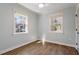 Light-filled bedroom features hardwood floors, ceiling fan, and windows offering natural light at 35 Rogerson Dr, Chapel Hill, NC 27517