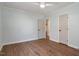 Bedroom featuring hardwood floors, a ceiling fan, and three doors at 35 Rogerson Dr, Chapel Hill, NC 27517