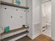 Bright entryway with storage and bench seating, leading to a half-bath at 35 Rogerson Dr, Chapel Hill, NC 27517