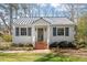 Charming home features a metal roof, painted brick stairs, and beautiful landscaping at 35 Rogerson Dr, Chapel Hill, NC 27517