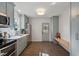 Open kitchen layout with stainless steel appliances, white countertops, and hardwood floors at 35 Rogerson Dr, Chapel Hill, NC 27517