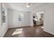 Living room featuring hardwood floors, large window, and view into kitchen at 35 Rogerson Dr, Chapel Hill, NC 27517
