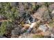 Stunning aerial perspective of a beautiful home with a long driveway surrounded by mature trees and lush landscaping at 3513 Eden Croft Dr, Raleigh, NC 27612
