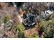 Aerial view of a beautiful home with a dark roof surrounded by lush greenery and trees at 3513 Eden Croft Dr, Raleigh, NC 27612