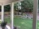 Lush backyard view showcasing a well-manicured lawn, mature trees, and vibrant blue hydrangea bushes at 3513 Eden Croft Dr, Raleigh, NC 27612