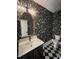 Stylish powder room features animal print wallpaper, black and white tile, plus a black vanity at 3513 Eden Croft Dr, Raleigh, NC 27612