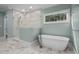 Elegant bathroom with a soaking tub, glass-enclosed shower, and marble accents at 3513 Eden Croft Dr, Raleigh, NC 27612
