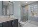 Bathroom boasts blue walls, glass enclosed shower, and modern fixtures at 3513 Eden Croft Dr, Raleigh, NC 27612
