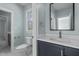 Stylish bathroom boasts a light blue wall color with modern features and tile at 3513 Eden Croft Dr, Raleigh, NC 27612