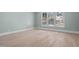 Serene bedroom with hardwood floors and large windows offering ample natural light at 3513 Eden Croft Dr, Raleigh, NC 27612