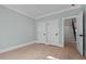 Spacious bedroom with light hardwood floors, white trim, and convenient access to the stairway at 3513 Eden Croft Dr, Raleigh, NC 27612