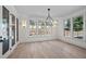 Bright dining room features a chandelier, large windows, and neutral paint at 3513 Eden Croft Dr, Raleigh, NC 27612