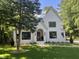 Charming two-story home with white brick, black trim, landscaped yard and a beautiful lawn at 3513 Eden Croft Dr, Raleigh, NC 27612