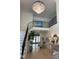 Bright foyer with hardwood floors, staircase with iron railing, and crystal chandelier at 3513 Eden Croft Dr, Raleigh, NC 27612