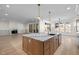 Open kitchen flows into the living room, featuring a large island with marble countertop at 3513 Eden Croft Dr, Raleigh, NC 27612