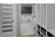 Bright laundry room with gray cabinets and open shelving for efficient organization and storage at 3513 Eden Croft Dr, Raleigh, NC 27612