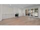 Bright living room features hardwood floors, fireplace, built-in cabinets and sliding glass doors at 3513 Eden Croft Dr, Raleigh, NC 27612