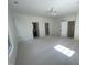 Spacious main bedroom bathed in sunlight features neutral carpet, paint, a ceiling fan, and en-suite bathroom at 3513 Eden Croft Dr, Raleigh, NC 27612