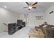 Spacious bonus room with ceiling fan, comfortable seating, and entertainment setup at 3528 Olive Glen Dr, Apex, NC 27502