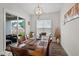 Inviting dining room with a large wooden table, stylish chandelier, and sliding door to the patio at 3528 Olive Glen Dr, Apex, NC 27502