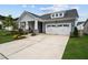 Charming home with a two-car garage, a well-manicured lawn, and a welcoming front porch at 3528 Olive Glen Dr, Apex, NC 27502