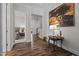 Open hallway with hardwood floors, decorative artwork and an adjacent bedroom and staircase at 3528 Olive Glen Dr, Apex, NC 27502