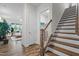 Bright hallway leads to staircase and living area, showcasing the home's layout at 3528 Olive Glen Dr, Apex, NC 27502