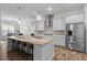 Gourmet kitchen with stainless steel appliances and an island with bar seating at 3528 Olive Glen Dr, Apex, NC 27502
