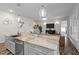 Open-concept kitchen showcasing granite countertops, a large island, and stainless steel appliances at 3528 Olive Glen Dr, Apex, NC 27502