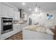 Modern kitchen with white cabinets, stainless steel appliances, and a large island with a marble countertop at 3528 Olive Glen Dr, Apex, NC 27502