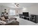 Comfortable living room featuring large speakers and a window with natural light at 3528 Olive Glen Dr, Apex, NC 27502