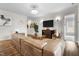 Spacious living room featuring a large sectional sofa, hardwood floors, and modern decor at 3528 Olive Glen Dr, Apex, NC 27502