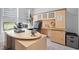 Bright office features a wooden desk, executive chair, built-in storage, and tranquil views at 3528 Olive Glen Dr, Apex, NC 27502