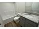 Full bathroom featuring a tub with shower, granite-topped vanity and modern fixtures at 38 Flatland Dr, Princeton, NC 27569
