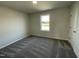 Cozy bedroom with large window and neutral carpet, offering a comfortable and peaceful retreat at 38 Flatland Dr, Princeton, NC 27569