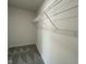 Empty closet with minimal wire shelving and gray carpeting at 38 Flatland Dr, Princeton, NC 27569