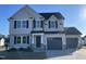 Two-story home with gray siding, black shutters, and a two-car garage at 38 Flatland Dr, Princeton, NC 27569