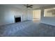 Spacious living room with a fireplace, neutral walls, and plush gray carpeting at 38 Flatland Dr, Princeton, NC 27569