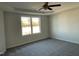 Spacious main bedroom with tray ceiling, fan and large window providing ample natural light at 38 Flatland Dr, Princeton, NC 27569