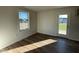 Bright room with wood-look flooring, a large window, and access to the backyard at 38 Flatland Dr, Princeton, NC 27569