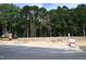 Cleared lot ready for construction with heavy equipment, surrounded by trees and a neighborhood sign at 3821 Fairway View Dr # 11, Fuquay Varina, NC 27526